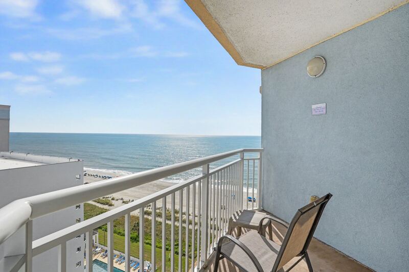 Private balcony at Holiday Sands South Beach Unit 1129 with chairs facing the Atlantic Ocean